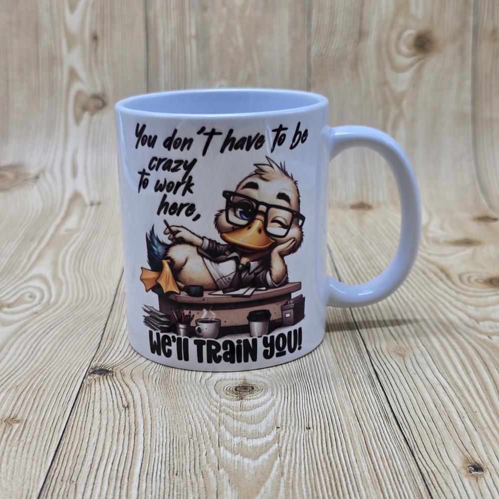 Mok – Grappige Quote – “You Don’t Have to Be Crazy to Work Here”